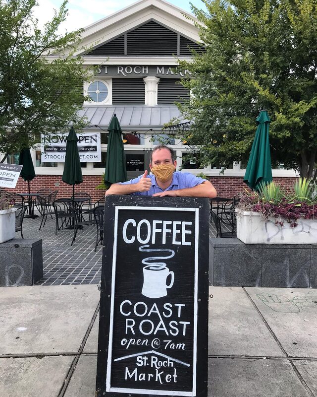 Kevin Pedeaux with Coast Roast Coffee sign at St. Roch Market